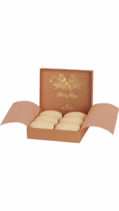 A box of six decorative soaps with floral designs, partially open, showcasing the contents inside.