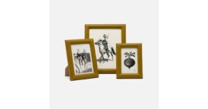 Three dark olive leather picture frames display black-and-white images of people and a vegetable.