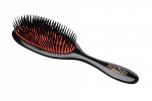 A dark ruby Mason Pearson hairbrush with a black handle and bristles.