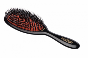 A dark ruby hairbrush with nylon bristles and a black handle, designed for detangling hair.