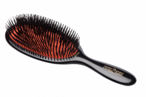 Large Mason Pearson hairbrush with black bristles and a dark ruby handle, designed for detangling hair.