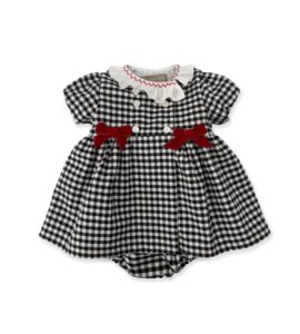 Black and white gingham dress with red bows and a ruffled collar.