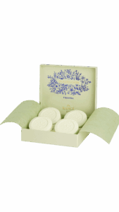 A light green box contains four round, embossed soaps labeled "Freesia.