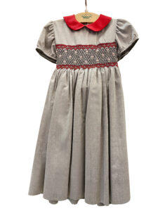Gray cotton dress with short puff sleeves, red collar, and decorative red smocking at the waist.