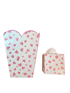 Scalloped-edge wastebasket and tissue box, both decorated with pink clover flowers.