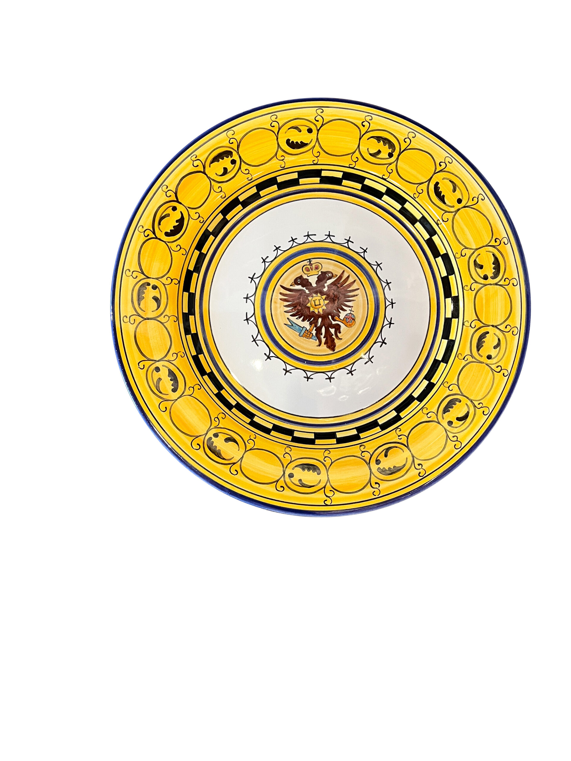 f-lli-mari-palio-aquila Decorative plate featuring a central eagle emblem, surrounded by a yellow and black patterned border.
