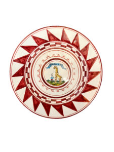 Ceramic plate with red geometric patterns and a central illustration of a giraffe and a lantern.