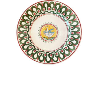Ceramic plate with intricate green and red patterns, featuring a central illustration of a duck.