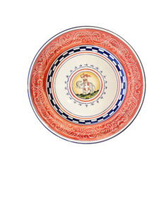 Ceramic plate with intricate red and blue patterns, featuring a central illustration of a horse and a flag.