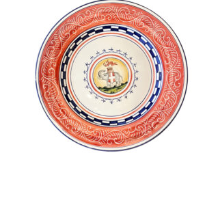 Ceramic plate with intricate red and blue patterns, featuring a central illustration of a horse and a flag.