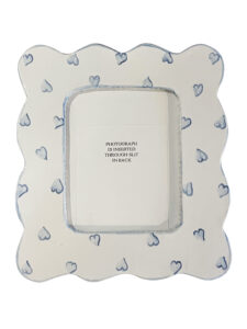 A decorative picture frame with blue hearts, featuring a slot for inserting a photograph.