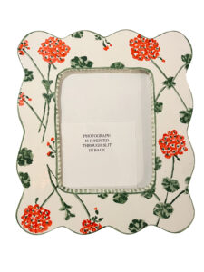 Decorative picture frame with red geraniums, featuring a note about inserting photographs from the back.