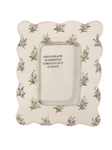 Decorative medium picture frame with floral design and a slot for inserting a photograph.
