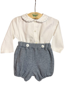 White long-sleeve shirt with a scalloped collar paired with gray checkered shorts.