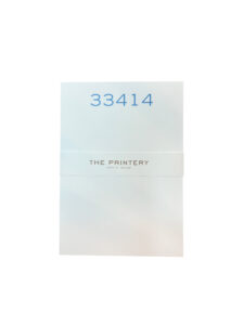 A folded card with the number "33414" and "THE PRINTERY" printed on it.