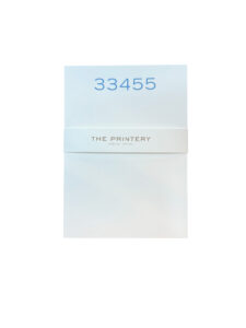 A white notepad with the number "33455" and "THE PRINTERY" printed on the cover.