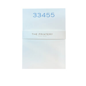 A white notepad with the number "33455" and "THE PRINTERY" printed on the cover.