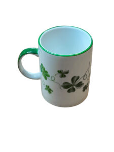 Clover green mug with a white body, featuring green clover designs and a matching rim.