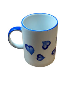 Ceramic mug with blue heart designs and a blue rim.