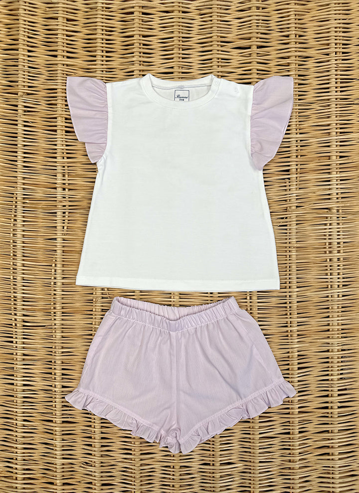 11405rosa_720x A white shirt with pink ruffled sleeves paired with matching pink shorts on a woven surface.