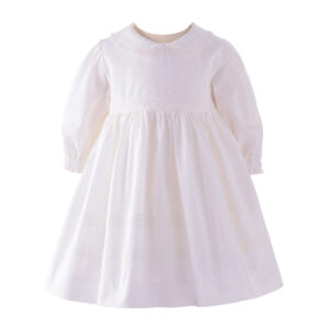 White dress with long sleeves and a collar, featuring delicate lace and textured fabric.