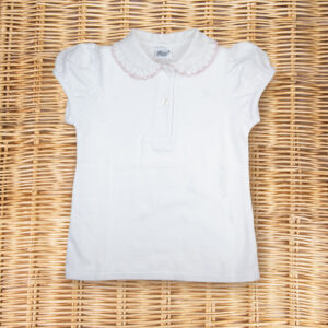 White short-sleeve polo shirt with a ruffled collar, laid flat on a woven surface.