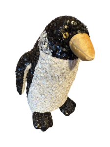 A large, sequined penguin plush with a golden beak and shiny black and white body.