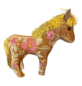 A plush horse toy with golden mane and embroidered flowers on a velvet body.
