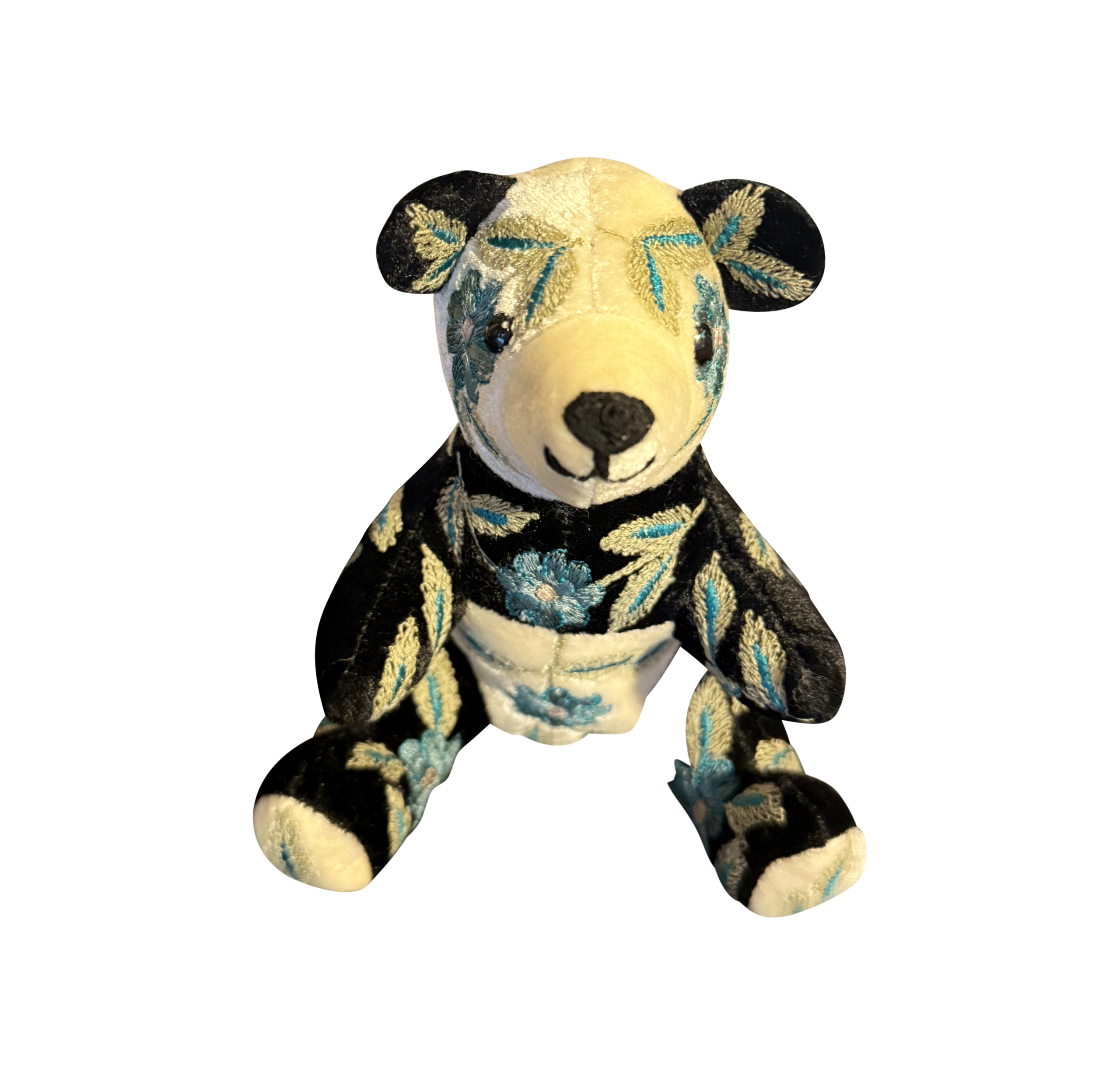 Anke Drechsel Moira Panda Small Silk Velvet Bear Small silk velvet bear with black and white fur, adorned with blue floral embroidery, sits upright.