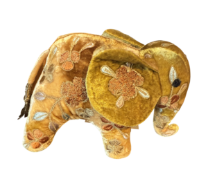 Miniature yellow silk elephant with floral embroidery and a decorative tail.