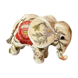 Miniature ivory velvet elephant with colorful floral embroidery and a tassel.