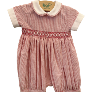 Red and white striped romper with a collar and embroidered waistband, hanging on a display.