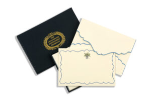 A black box containing elegant stationery with decorative envelopes and note cards.