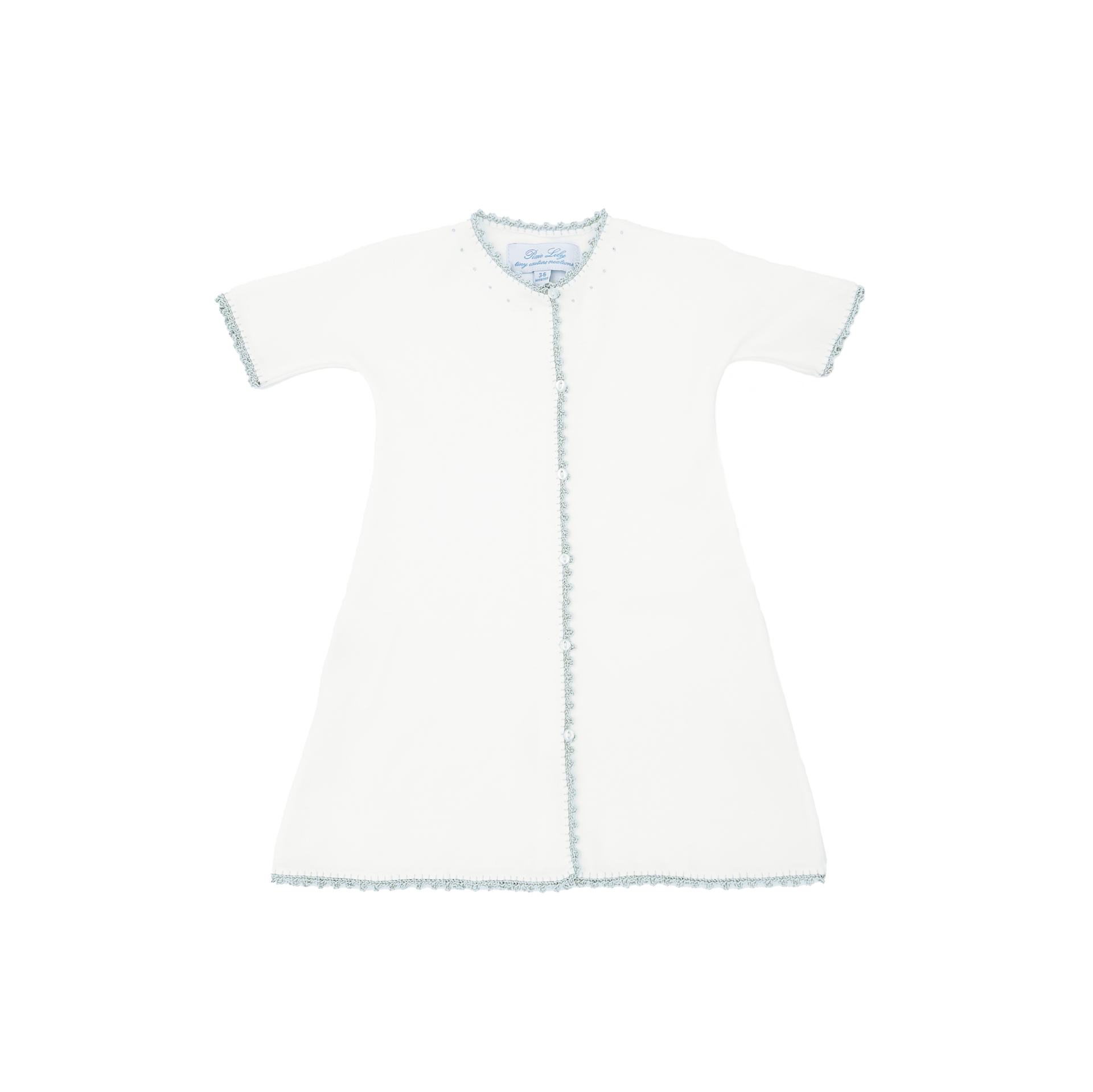 Short-sleeved white gown with blue trim and button closure, laid flat against a black background.