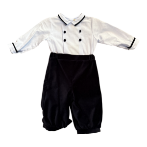 Two-piece boys' outfit featuring a white shirt with black accents and black velvet pants.