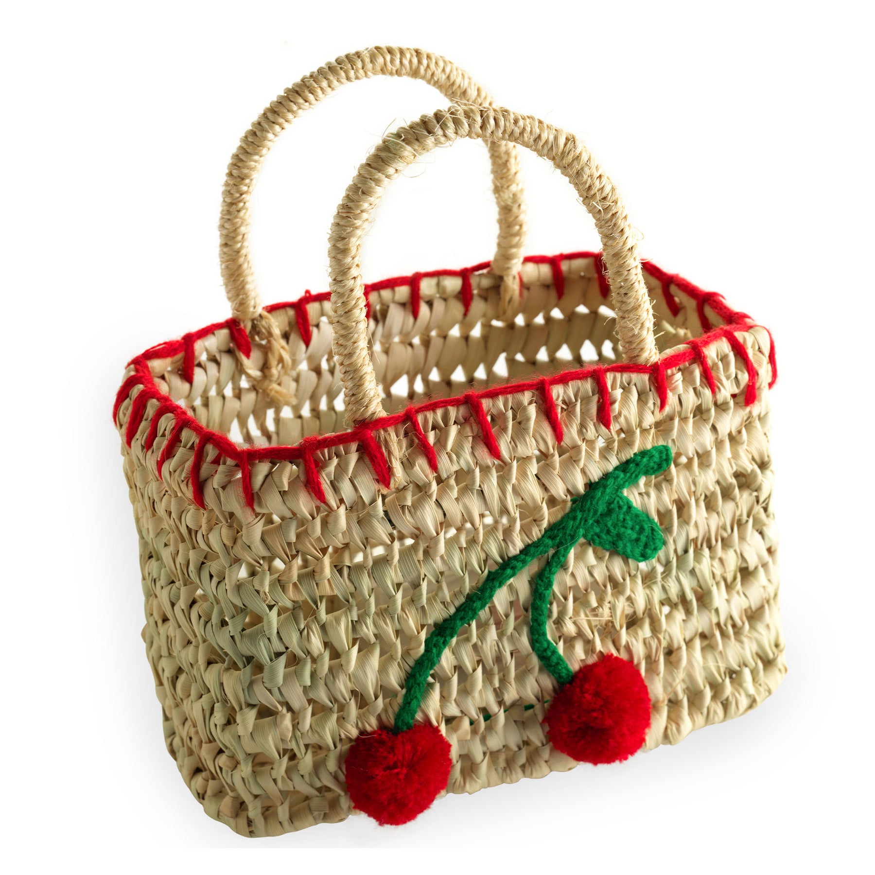Woven straw basket with red trim and cherry design, featuring two handles.