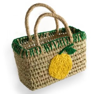 Woven straw basket with green trim and a yellow lemon applique on one side.