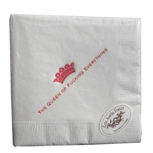 White cocktail napkin with red text reading "THE QUEEN OF FUCKING EVERYTHING" and a crown graphic.
