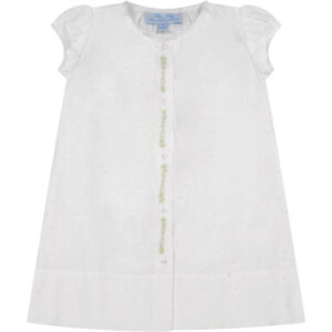 White dress with short puff sleeves and green decorative buttons down the front.