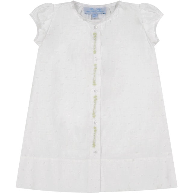 White dress with short puff sleeves and green decorative buttons down the front.