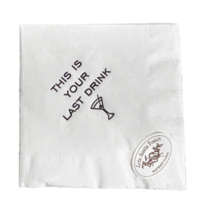White cocktail napkin with the text "THIS IS YOUR LAST DRINK" and a martini glass illustration.