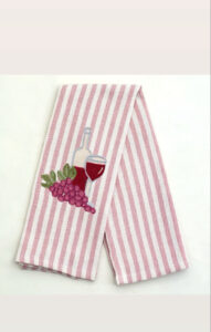 Striped kitchen towel featuring embroidered wine bottle, glass, and grapes.