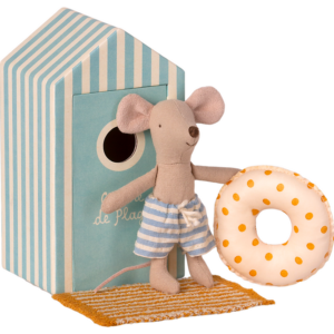 A mouse in striped shorts holds a polka-dotted float near a beach hut.