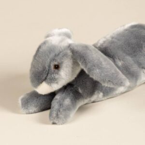 Gray plush rabbit lying on a light surface, with long ears and soft fur.