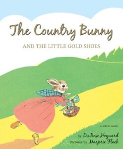 A bunny in a pink dress runs on a green hill, carrying a basket. The book title is prominently displayed above.