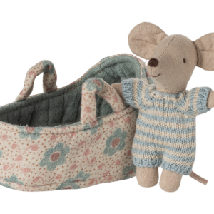 A soft toy mouse in a striped outfit stands next to a floral-patterned basket.