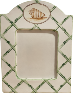 Large picture frame features a trellis design and a seashell illustration at the top.