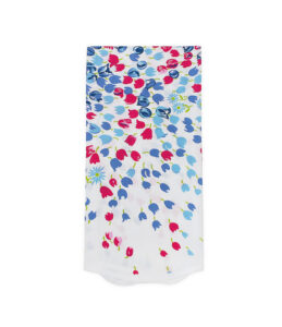 A white scarf featuring a colorful floral pattern in red, blue, and green.