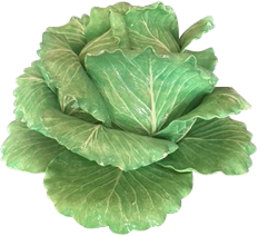Ceramic cabbage sculpture with detailed green leaves, placed on a wooden surface.
