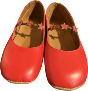 Bright red girls' shoes with a star-decorated strap and smooth rounded toes.